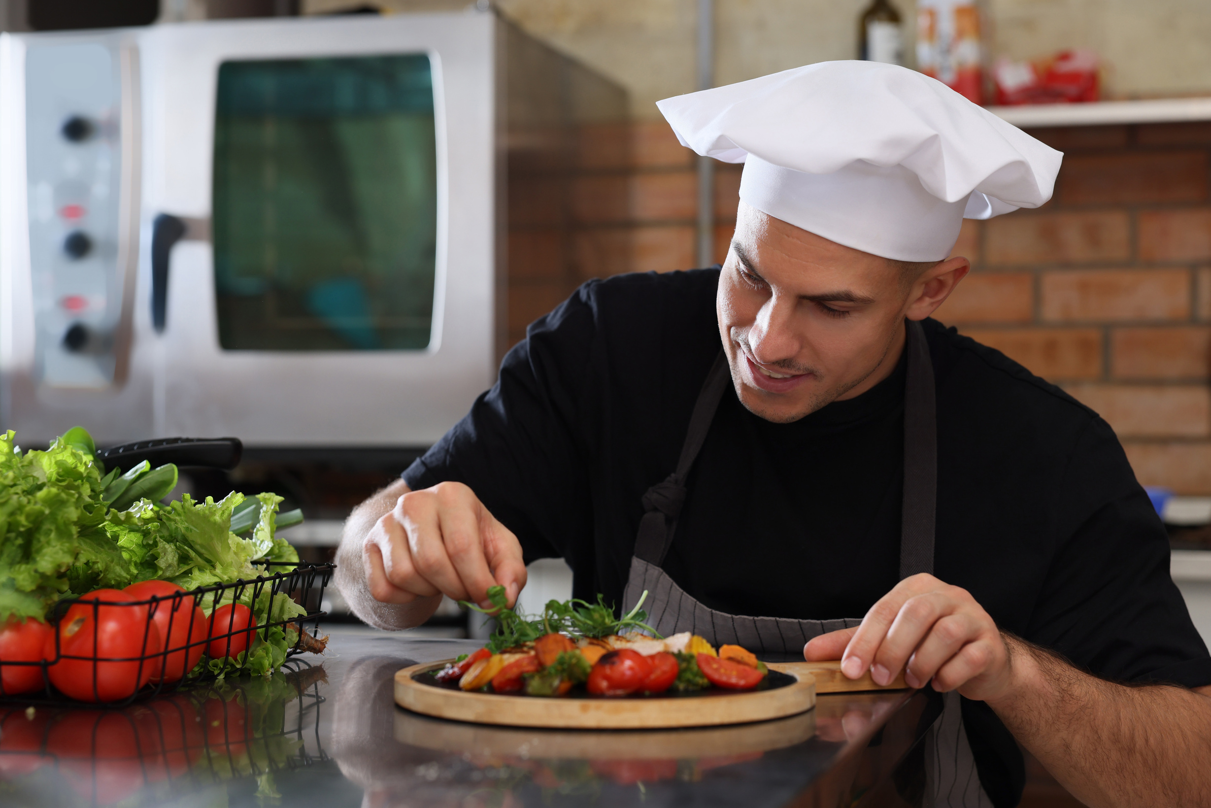 Professional Chef Adding Microgreens to Cooked Dish in Restauran